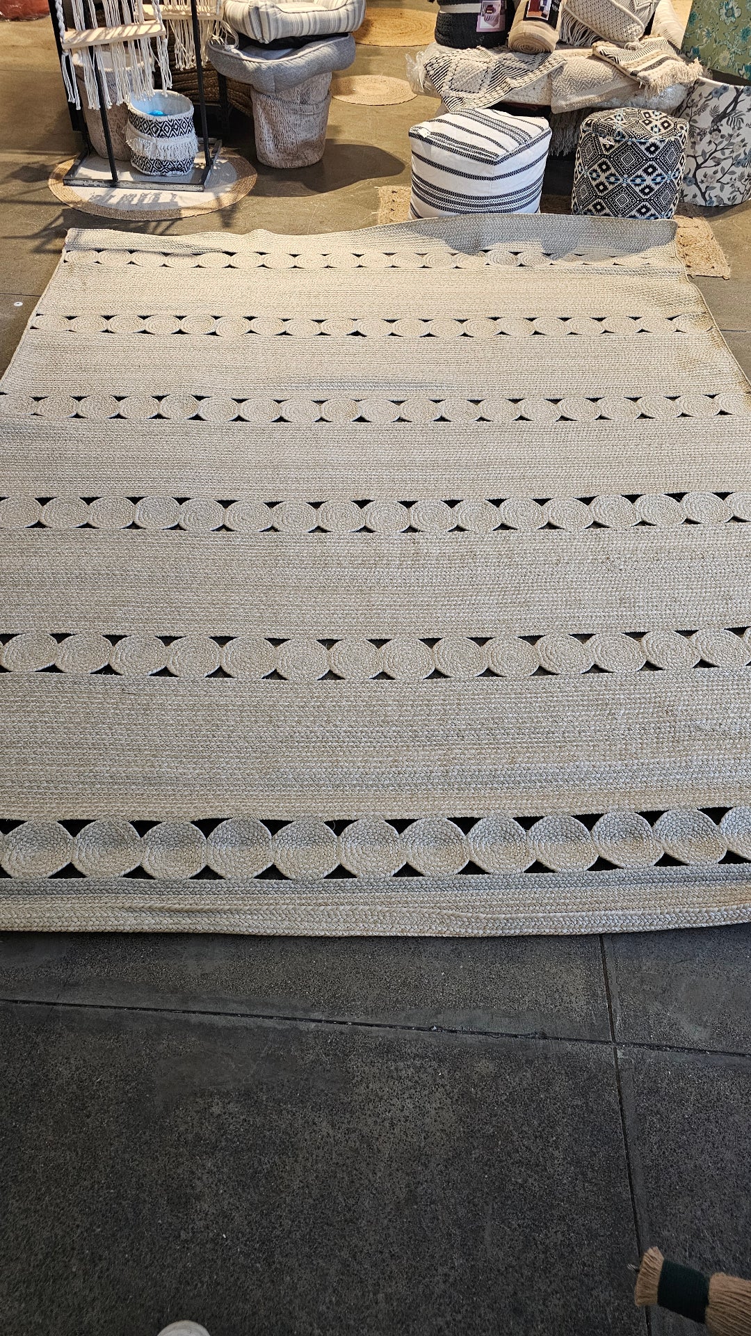 Full view of the braided jute rug with circle bands